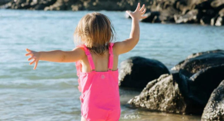 Girl in a pink bathing suit by SwimZip—Are pink swimsuits safe?