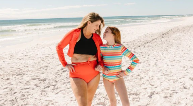 Mother and daughter in stylish light-colored modest swimwear by SwimZip at the beach—Cute modest bathing suits for coverage and style