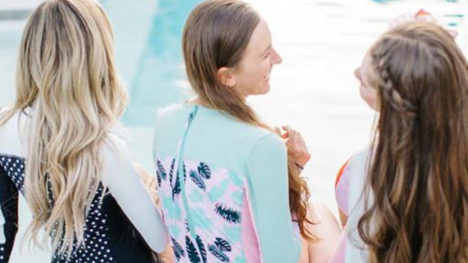 Friends in SwimZip's one-piece swimsuits by the pool—How to fix a bathing suit that is too small