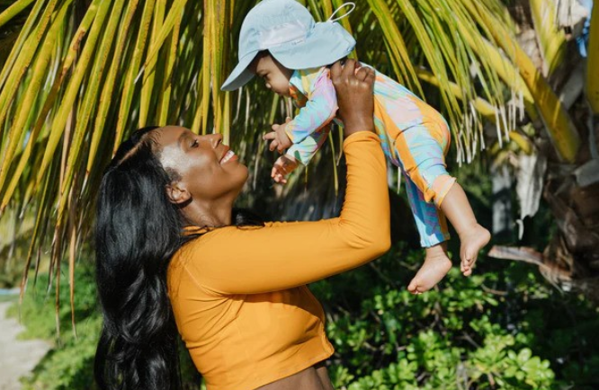 A mother with her child in the sun wearing SwimZip's sun-protective swimsuits—Skin cancer screening (a guide)