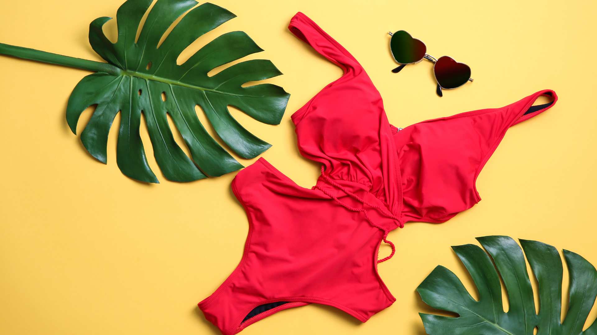 Red one-piece swimsuit, sunglasses and leaves—How to stretch out a one-piece swimsuit