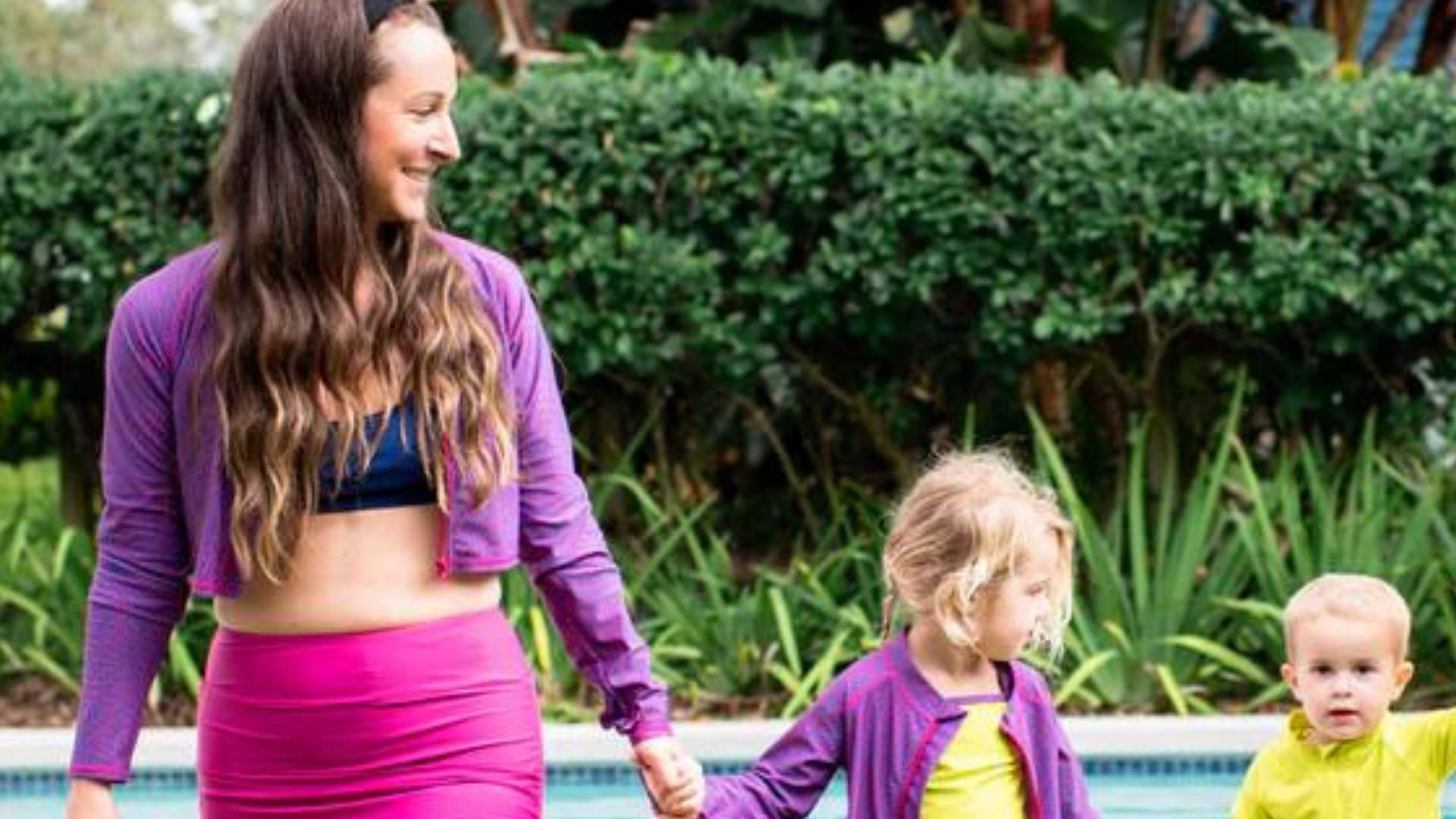 Mom and her kids in the SwimZip sun-protective swimwear—What are the best swimsuits for moms?