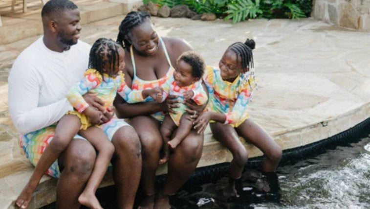 Family in a matching Surf's Up collection by SwimZip by the pool—What is the best swimsuit color to wear in the pool?